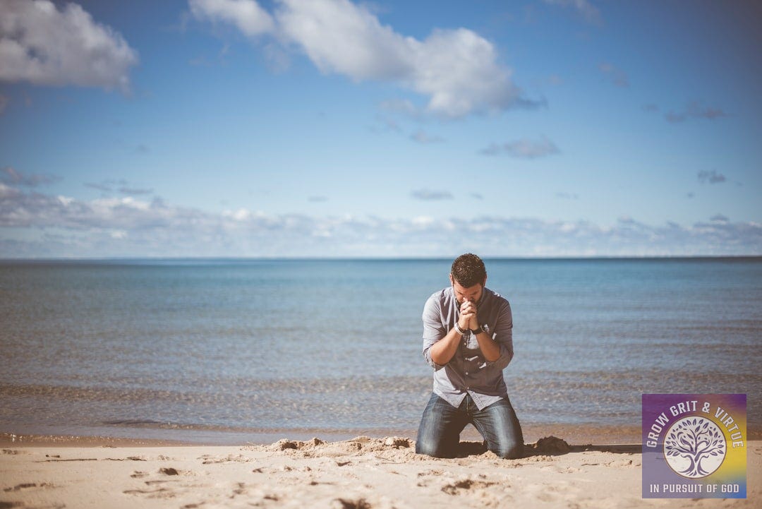 man kneeling down near shore