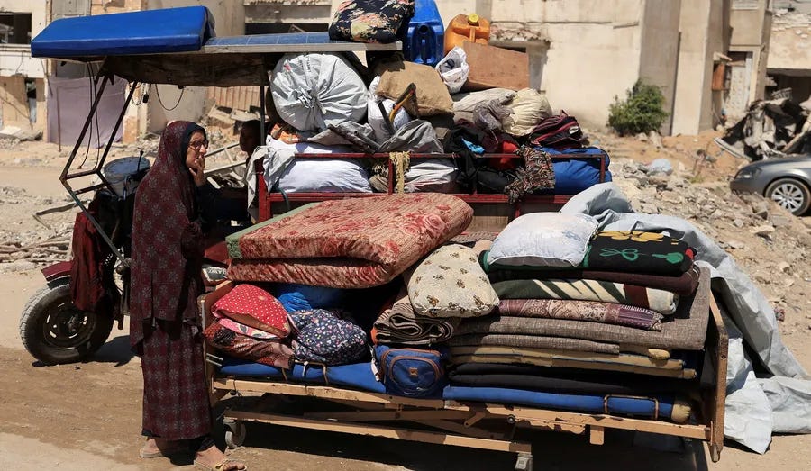 Una mujer desplazada espera con las pertenencias de su familia en la ciudad de Gaza el lunes. Una mujer desplazada espera con las pertenencias de su familia en la ciudad de Gaza el lunes.