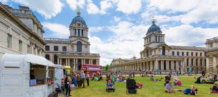 People sitting on grass in front of the Old Royal Naval College People sitting on grass in front of the Old Royal Naval College