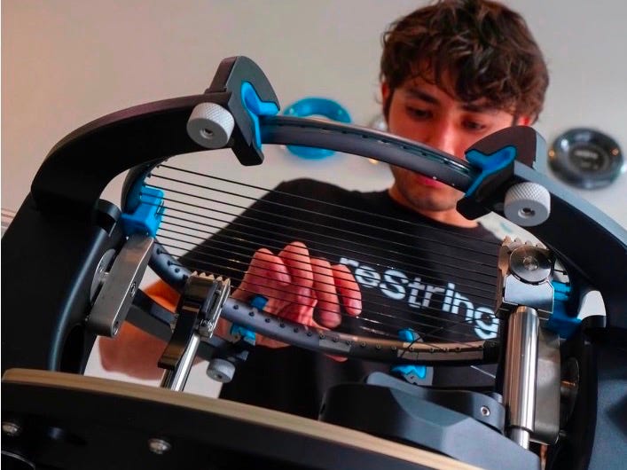 A racquet being restrung on a stringing machine by a reString team member. A racquet being restrung on a stringing machine by a reString team member.