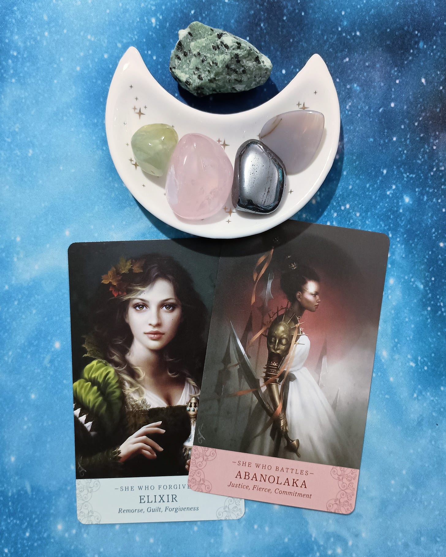 Is It Worth It? A Message From the Universe, 2 Elle Qui Oracle cards and crystals on a starry blue background Is It Worth It? A Message From the Universe, 2 Elle Qui Oracle cards and crystals on a starry blue background