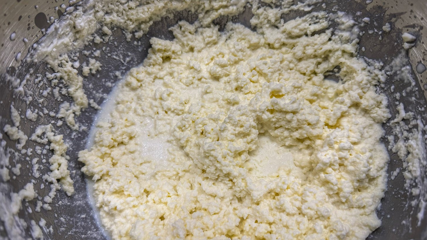 The inside of the mixing bowl, where butterfat has started separating from the buttermilk. The texture is somewhat similar to watery cottage cheese. 