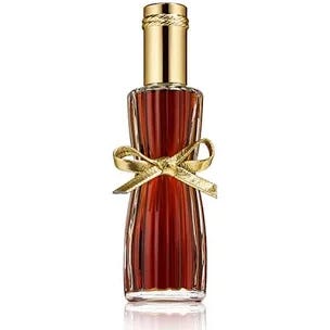 A small bottle of amber-colored perfume with a gold cap and a gold bow.