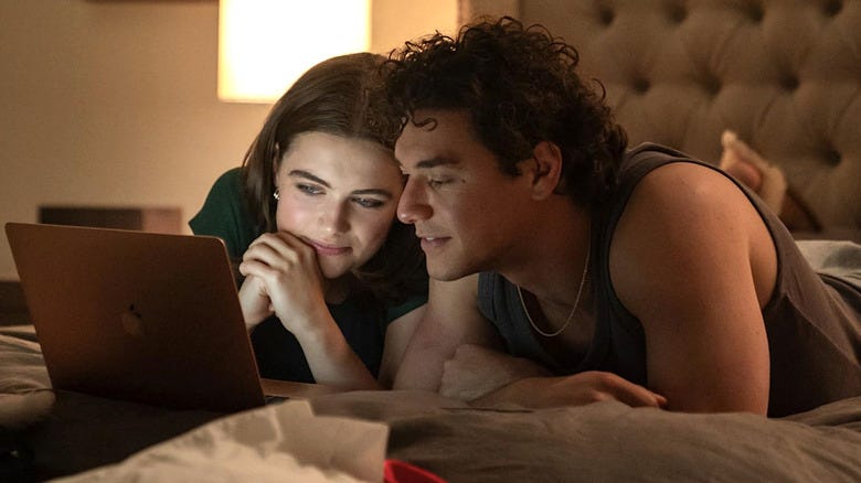 Off Campus Hannah and Garrett laying on a bed looking at a laptop. Ella Bright & Belmont Cameli Off Campus Hannah and Garrett laying on a bed looking at a laptop. Ella Bright & Belmont Cameli