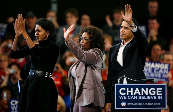 Democratic presidential hopeful Sen. Barack Obama, D-Ill., and his wife Michelle, left, wave to supporters with Oprah Winfrey, center, during a rally on Saturday in Des Moines, Iowa.
