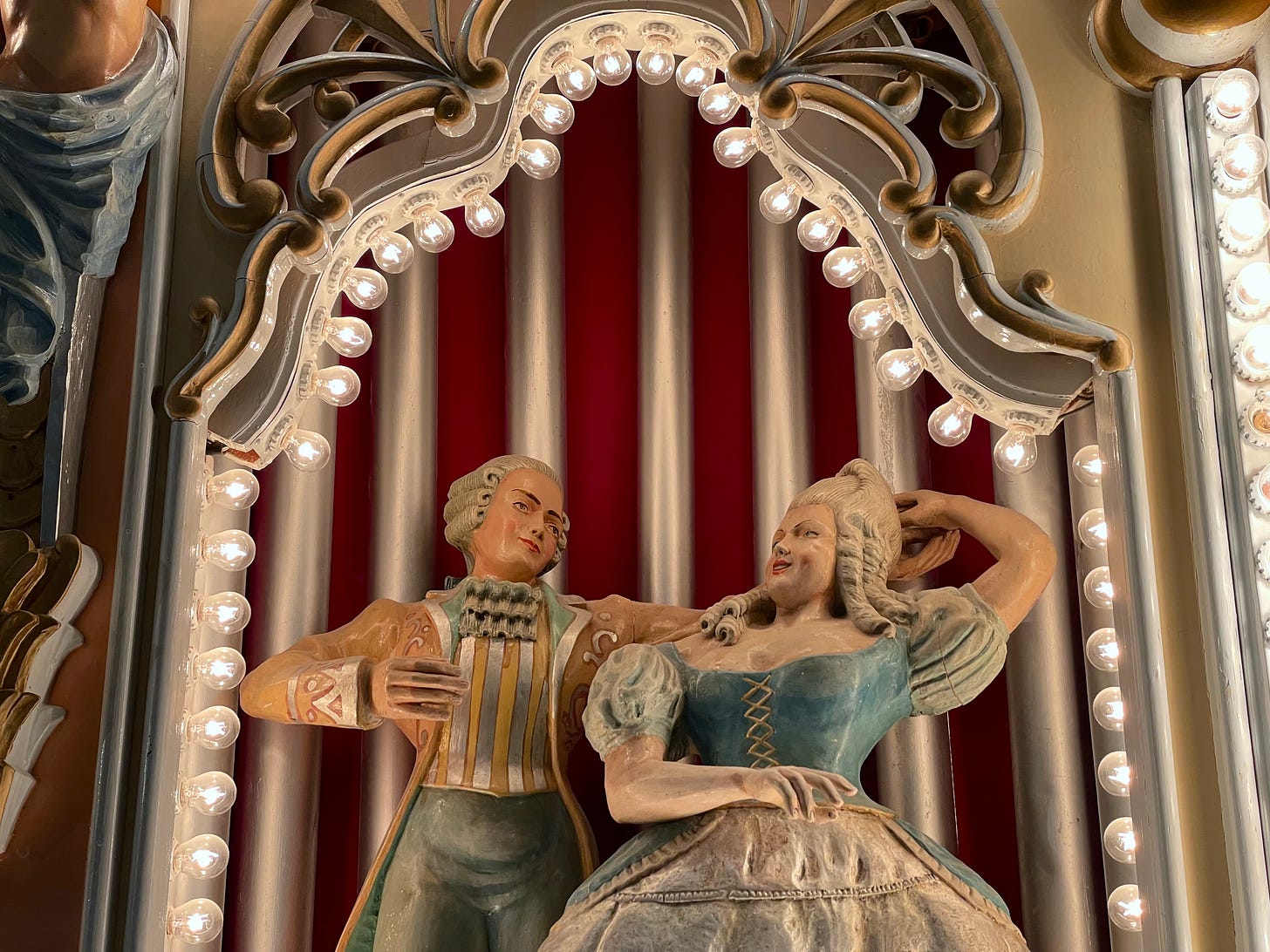 Two dancing figures on a pipe organ