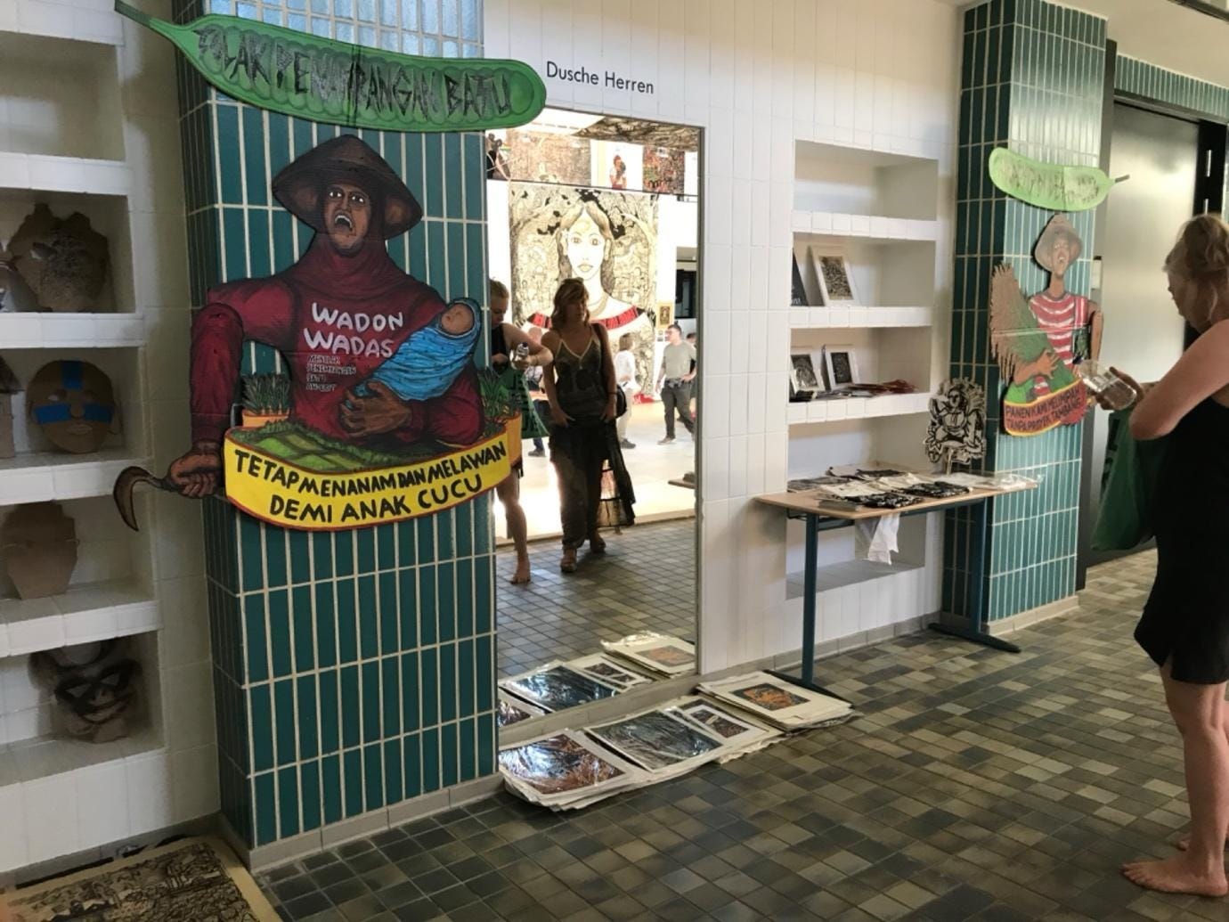 A room with a mirror and a wall with pictures on it
Description automatically generated A room with a mirror and a wall with pictures on it
Description automatically generated