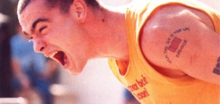 a young man with very short hair (Henry Rollins) bent over screaming/singing