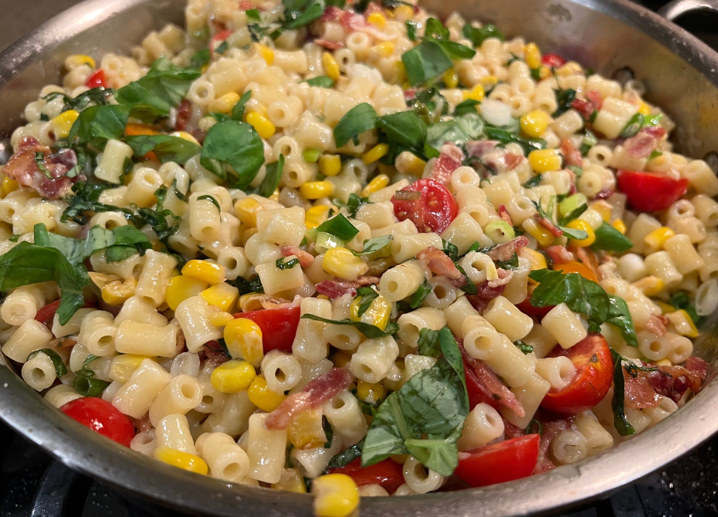 bacon and corn pasta with basil, cherry tomatoes, green onions, mozzarella and mascarpone