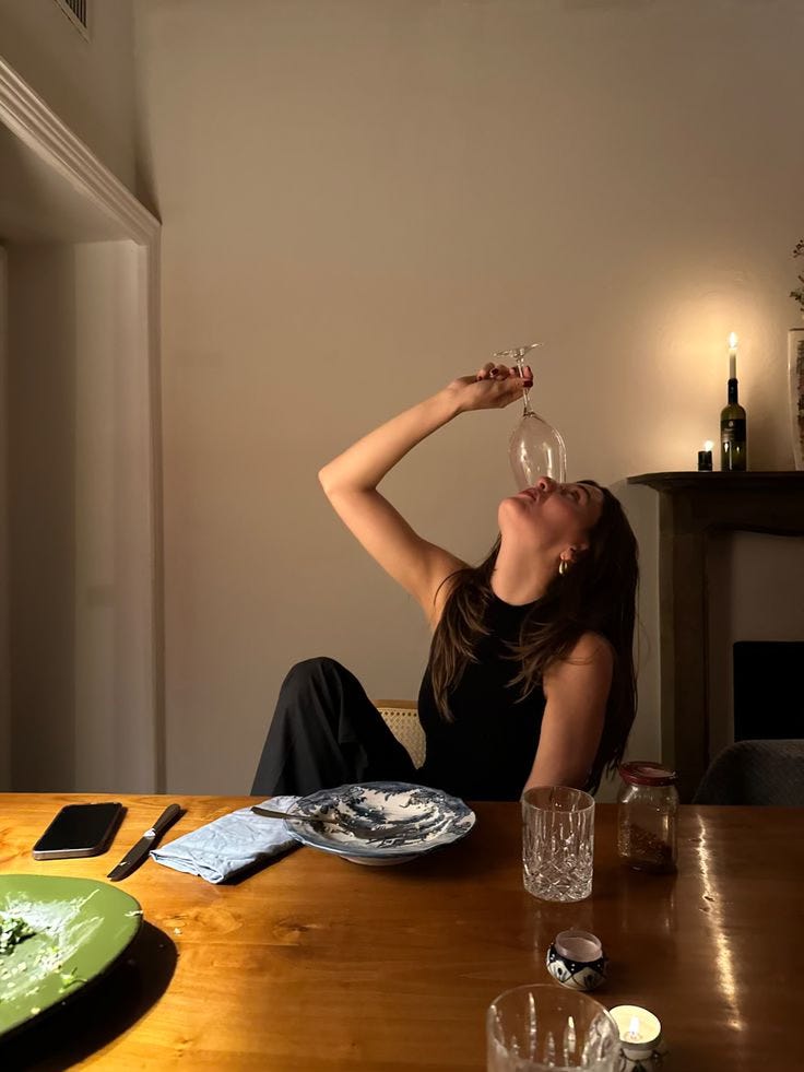 A woman relaxing at an open-air garden cafe in Bali, holding a glass of red wine, part of Southeast Asia's growing wine culture. A woman relaxing at an open-air garden cafe in Bali, holding a glass of red wine, part of Southeast Asia's growing wine culture.