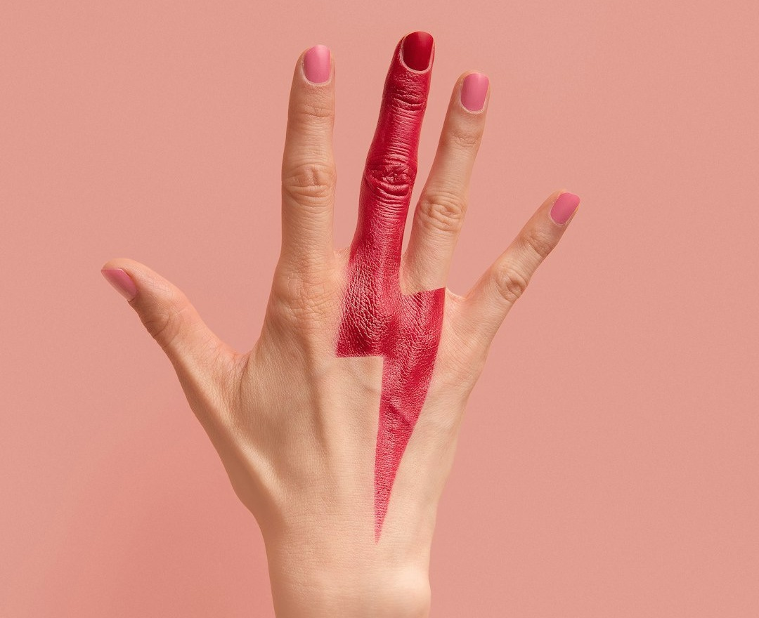 person with pink manicure on pink surface person with pink manicure on pink surface