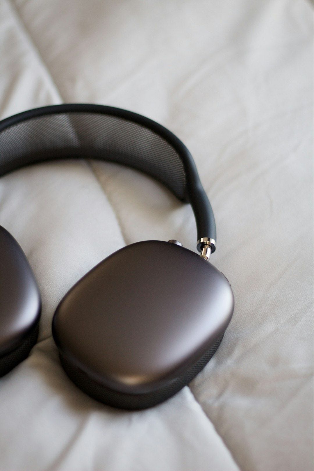a close up of a pair of headphones on a bed a close up of a pair of headphones on a bed