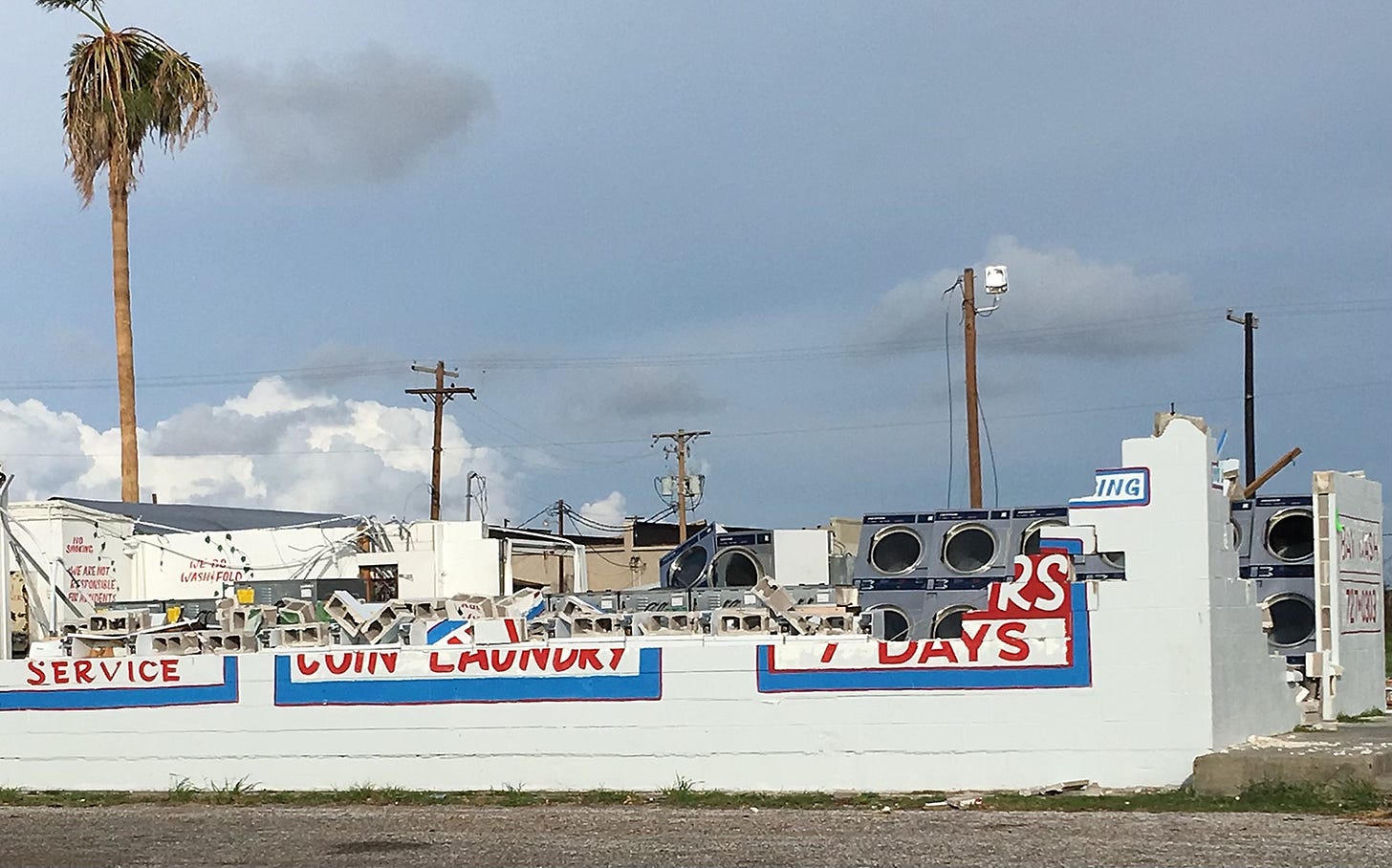 Photo of our laundromat with roof and walls gone, showing washers and dryers open to the atmosphere. Photo of our laundromat with roof and walls gone, showing washers and dryers open to the atmosphere.