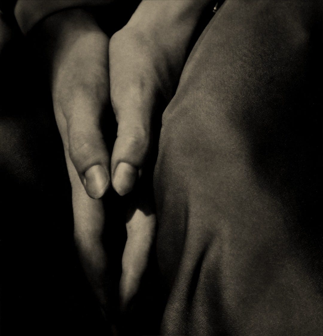 a black and white photo of a couple holding hands