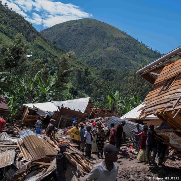 Congolese civilians gather after the death of their family members following rains in the village of Nyamukubi, Kalehe territory of the Democratic Republic of Congo May 6, 2023.
