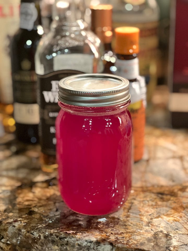 Cranberry rosemary syrup in the pot and after it's jarred.