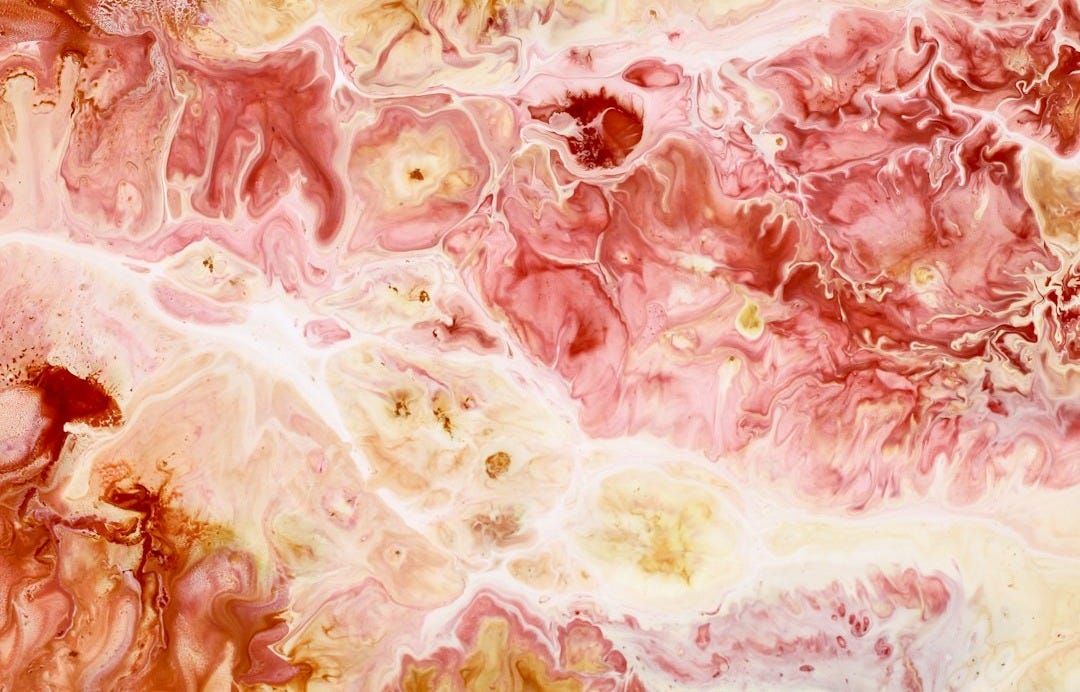 a close up of a pink and yellow marble a close up of a pink and yellow marble