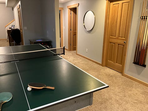 Ping pong, pool, Pac-Man, TV entertainment center, and dart board