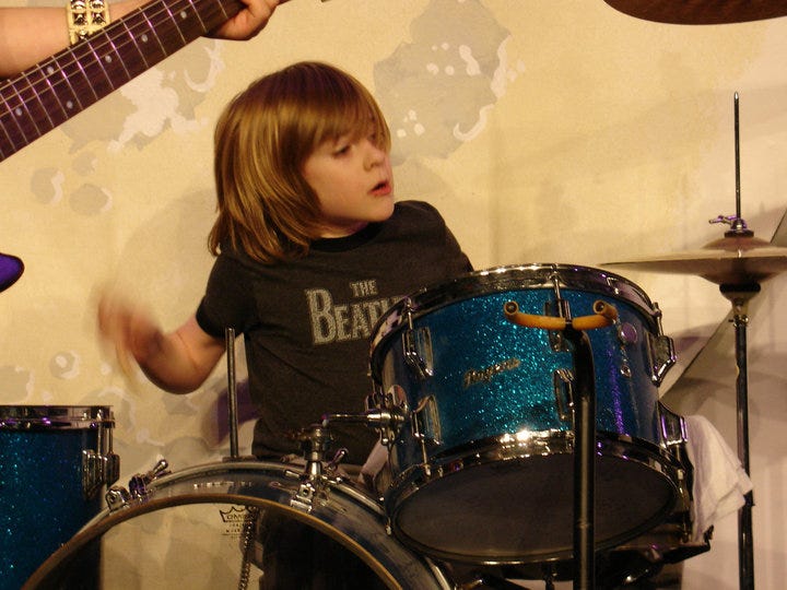 Henry playing bass and me playing drums at Second City Letters to Santa benefit sometime in the early 2000s.