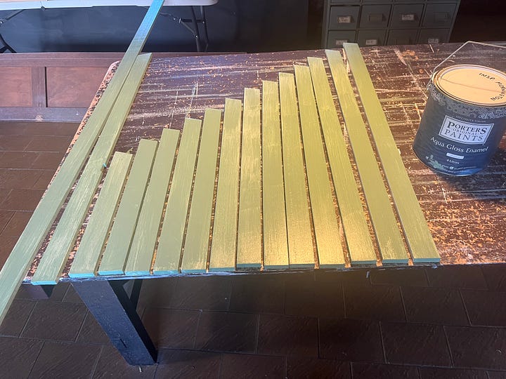 A wall with two interior windows and some trim being prepared