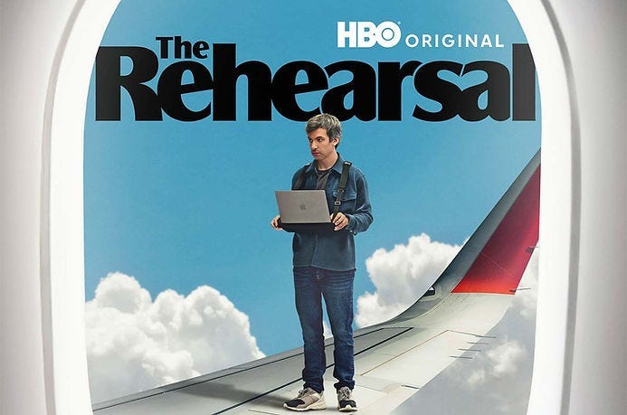 Man with laptop on airplane wing, framed by window. Blue sky and clouds. Text: “The Rehearsal,” “HBO Original.”