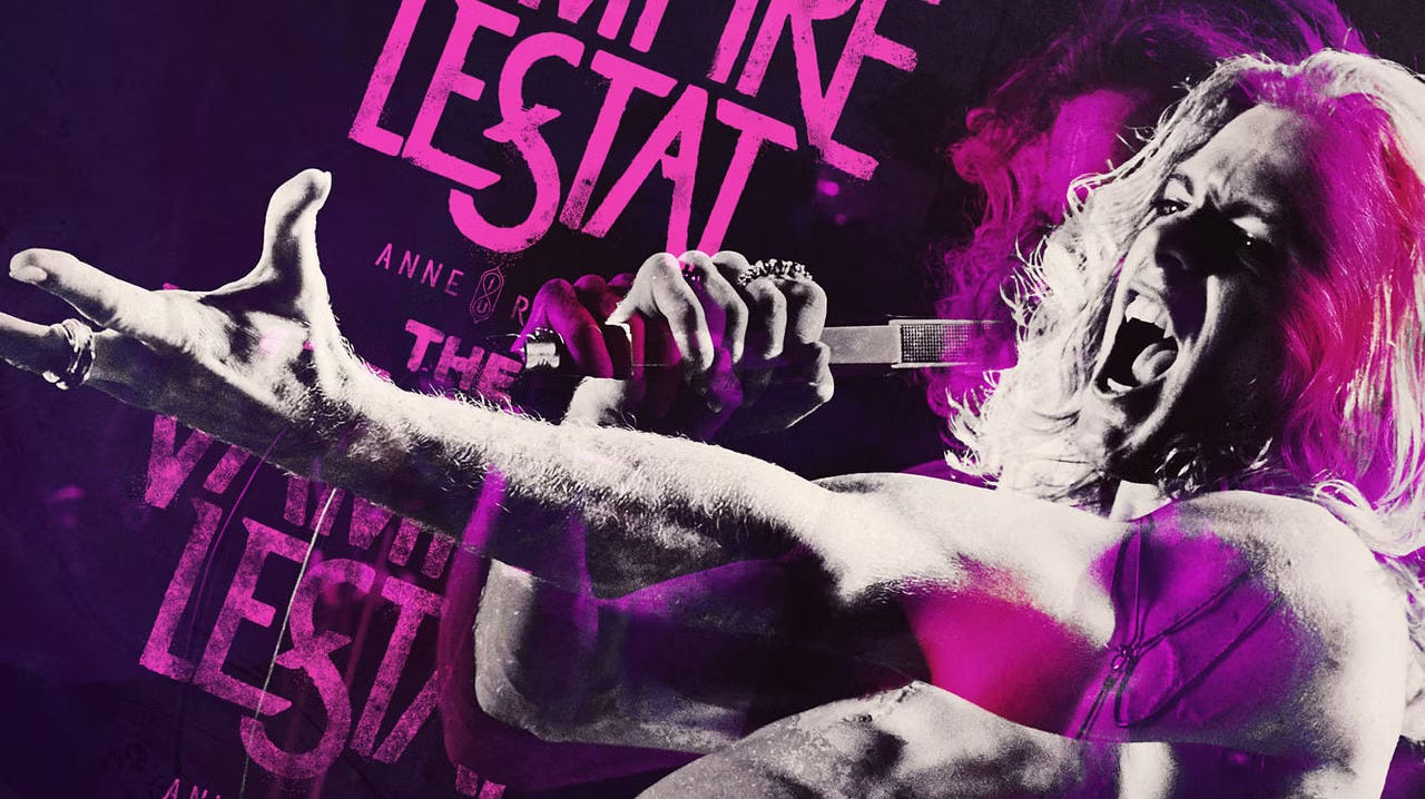 Lestat is singing with his hand outstretched. The image is black/white and pink.