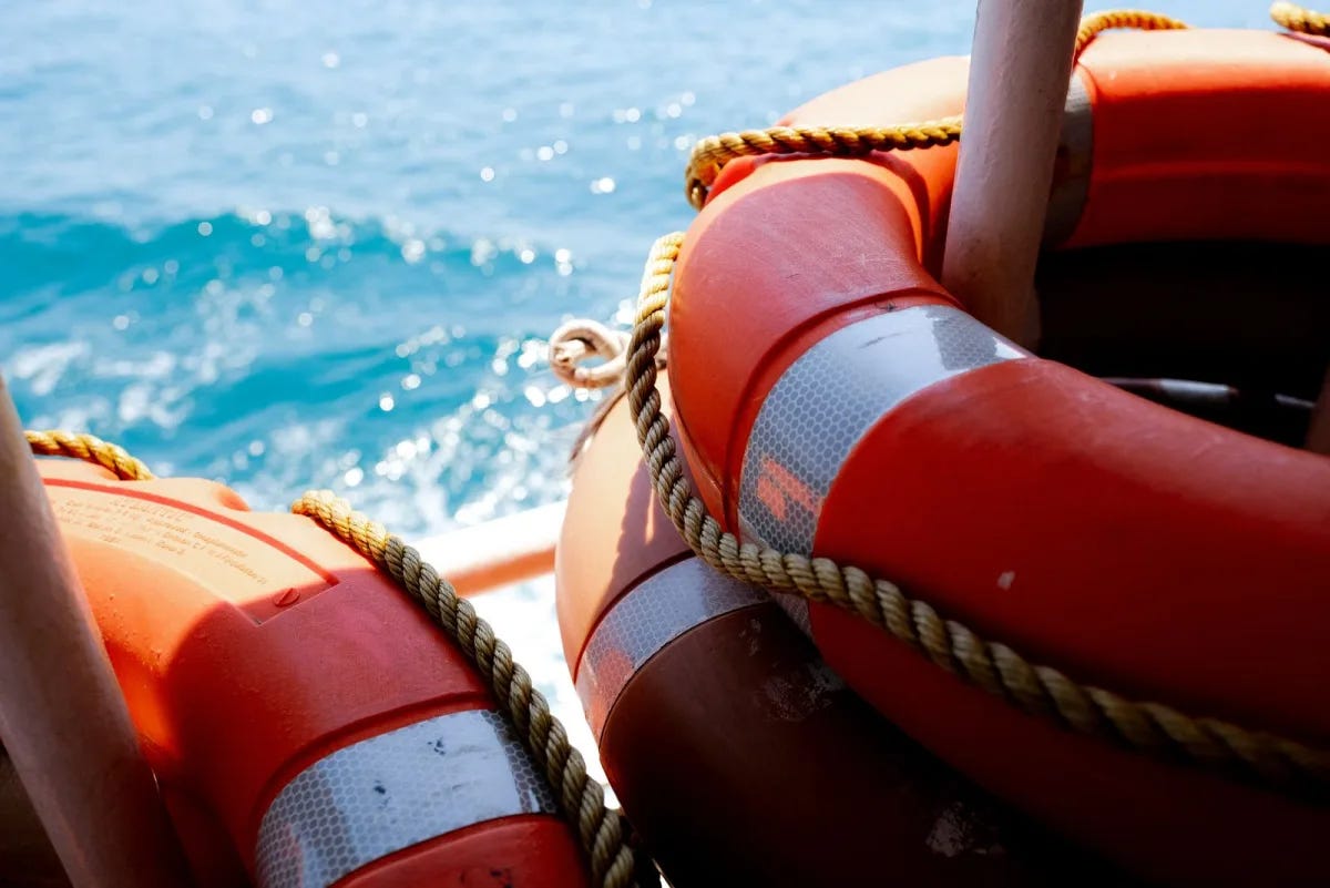 Orange lifebuoys and ropes on board a vessel on the ocean Orange lifebuoys and ropes on board a vessel on the ocean