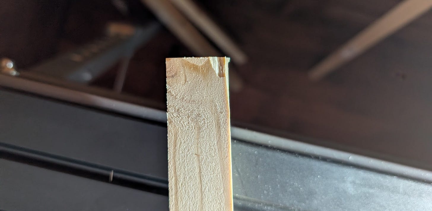 a cut end of lumber with a chip taken out of it
