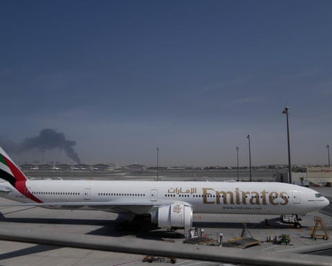 A plume of smoke is visible behind an Emirates plane at Dubai airport A plume of smoke is visible behind an Emirates plane at Dubai airport