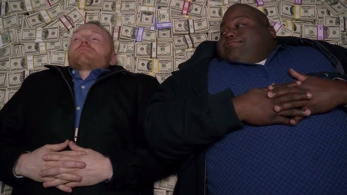 Two men lie on piles of bundled cash, symbolizing the excess capital flooding the venture capital market. Two men lie on piles of bundled cash, symbolizing the excess capital flooding the venture capital market.