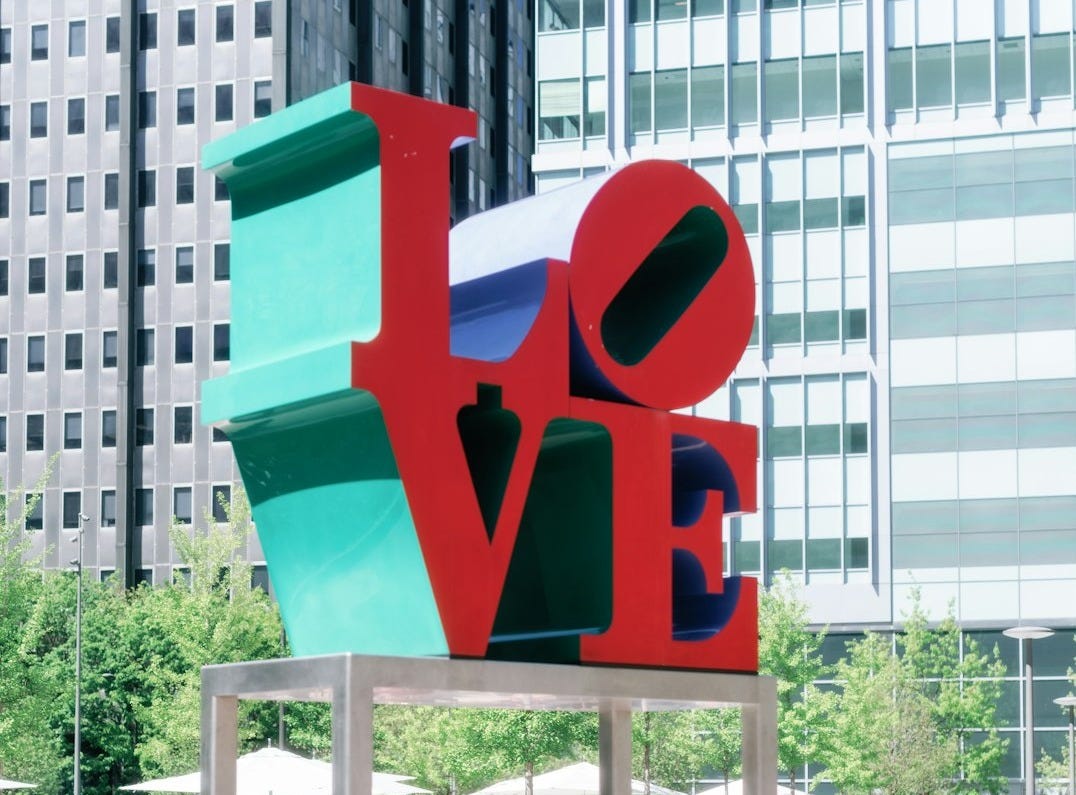 a sculpture of the word love in a city park