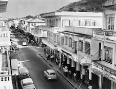 A street with buildings and cars. A street with buildings and cars.
