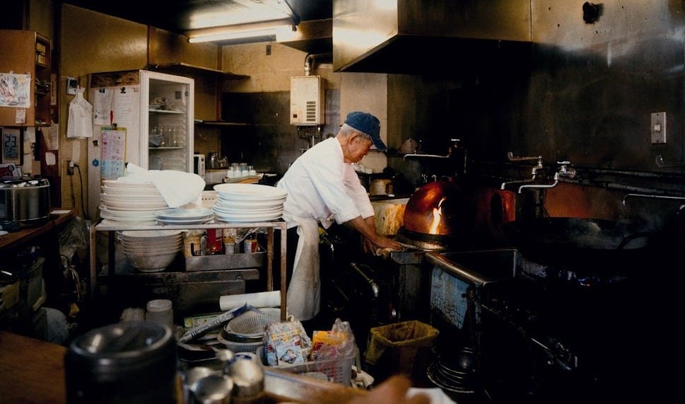 Chef working in a busy restaurant kitchen Chef working in a busy restaurant kitchen