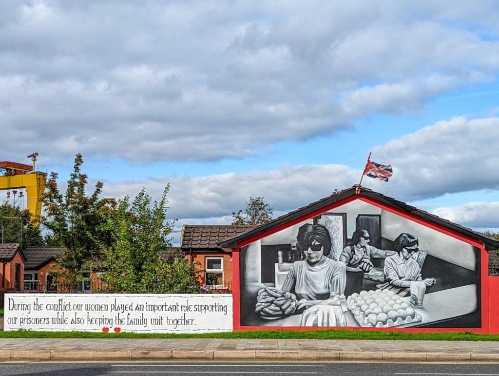 A mural of a person selling eggs on a building

Description automatically generated