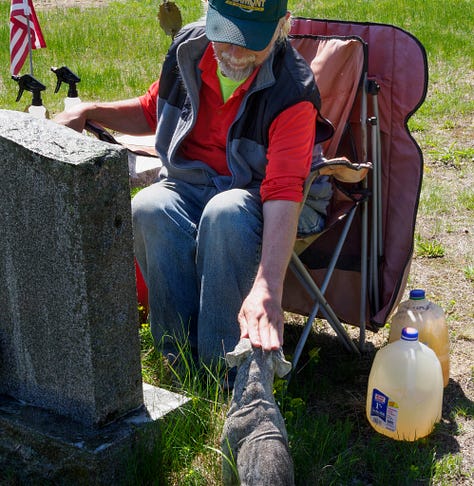 Carl cleaning gravestones