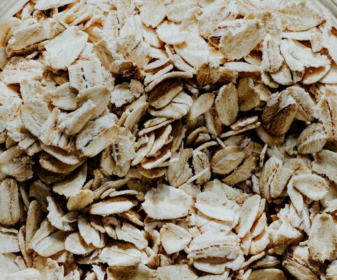 a glass bowl filled with oats on top of a table