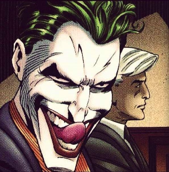 This may contain: the joker is smiling with his mouth open in front of two other men wearing suits
