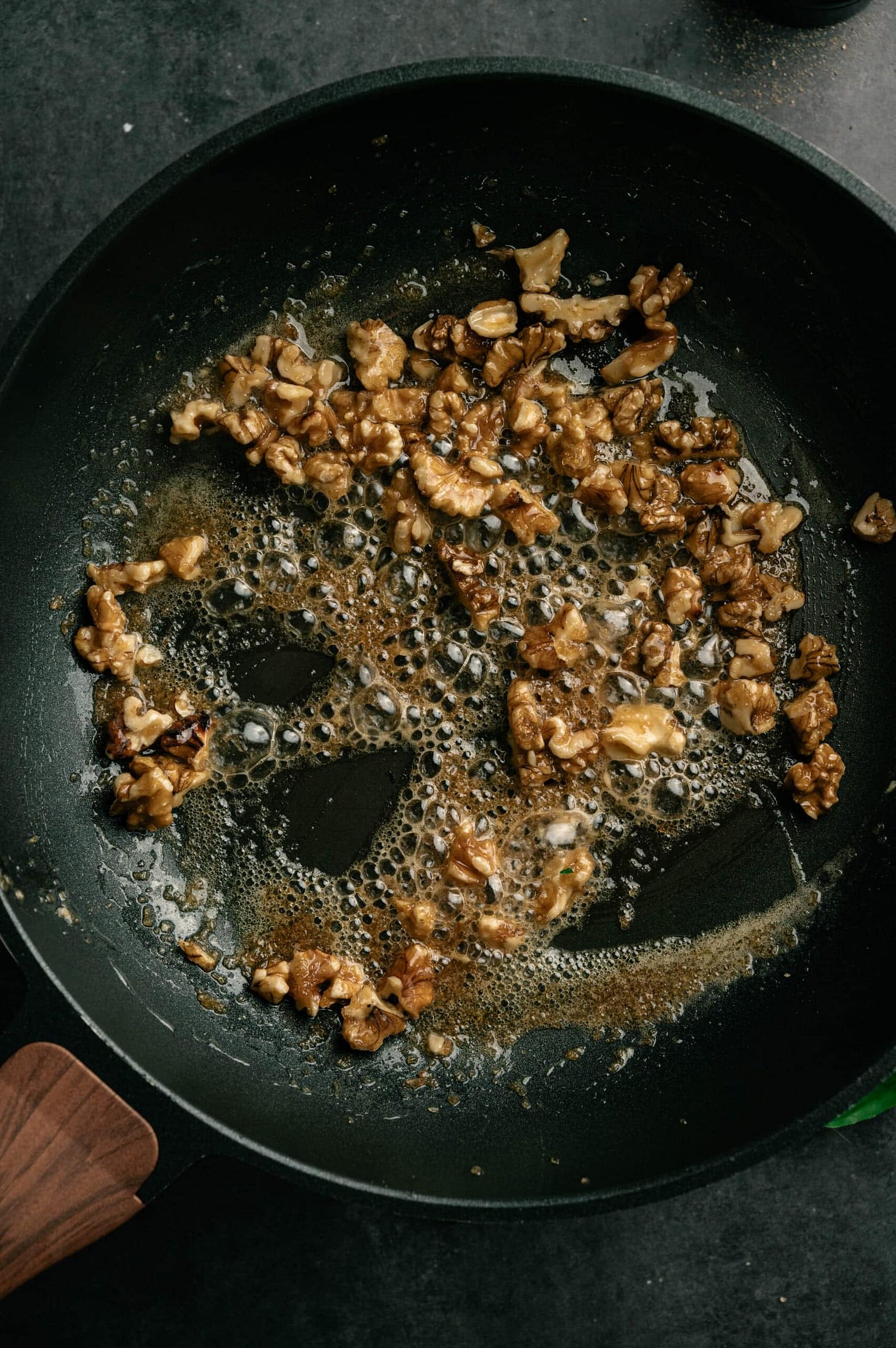 Step three: brown butter in a black skillet, with sugar and walnuts. 