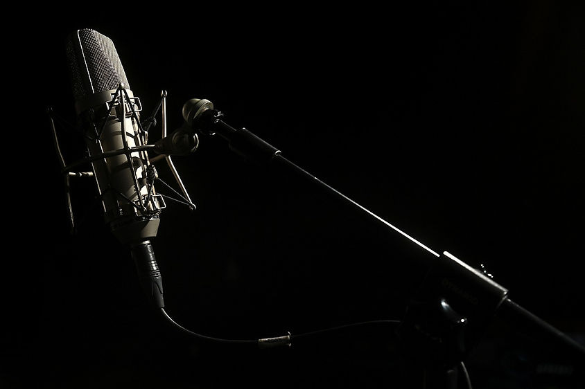 Podcasting microphone attached to an arm