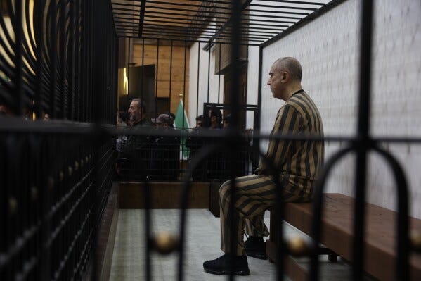 Atef Najib, former head of the Political Security Branch in the Daraa area during Bashar Assad's rule, sits in the defendants' cage during a trial session at the Palace of Justice in Damascus, Syria, Sunday, April 26, 2026. (AP Photo/Ghaith Alsayed) Atef Najib, former head of the Political Security Branch in the Daraa area during Bashar Assad's rule, sits in the defendants' cage during a trial session at the Palace of Justice in Damascus, Syria, Sunday, April 26, 2026. (AP Photo/Ghaith Alsayed)