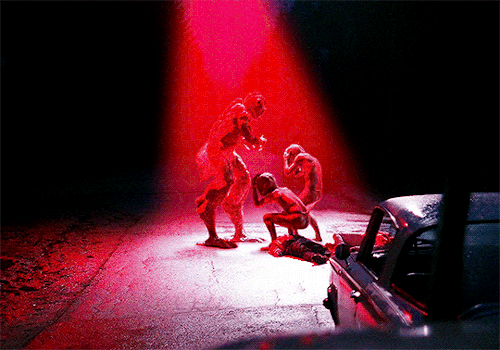 A large alien monster appears to threaten 2 smaller gray aliens cowering in fear as a red light shines over all of them. A large alien monster appears to threaten 2 smaller gray aliens cowering in fear as a red light shines over all of them.