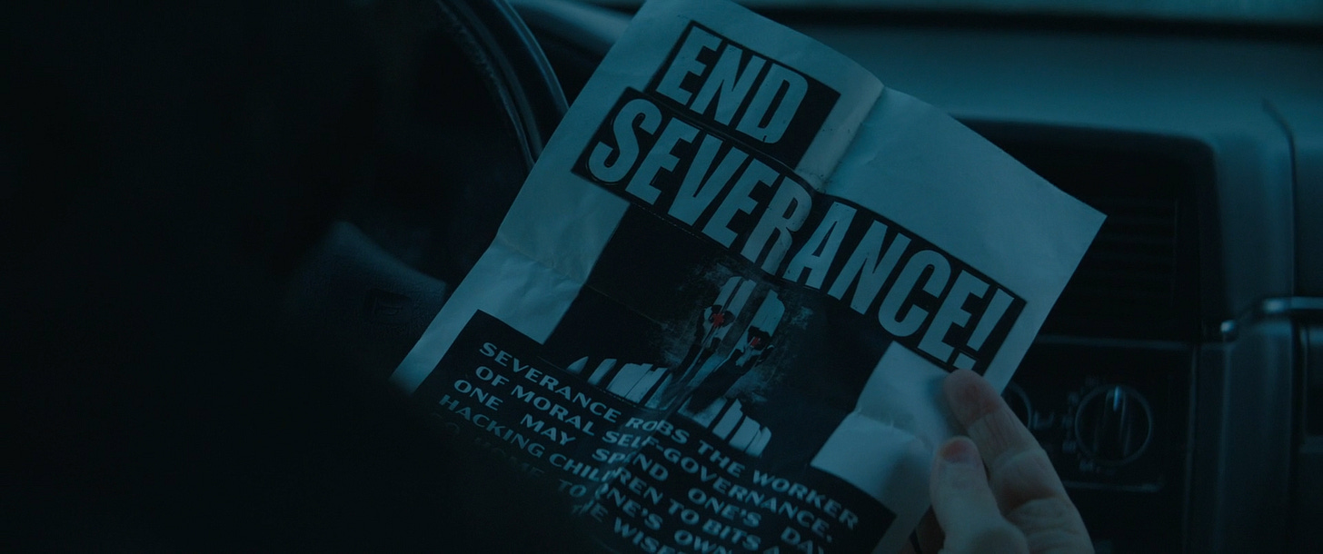 Mark holding the poster that says "End Severance"