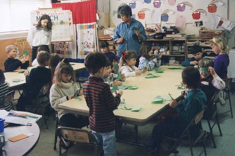 Children making paper shamrocks for St. Pat's Day