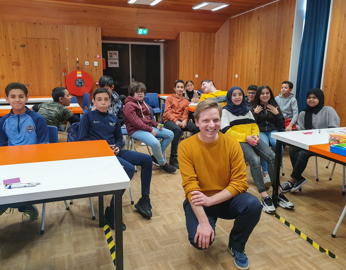 Jasper sitting in front of 20 children