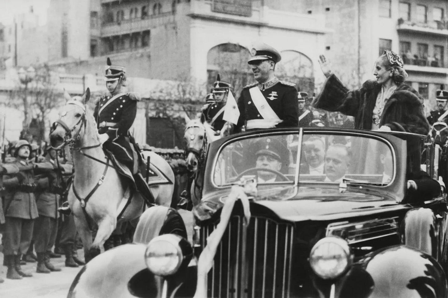 Eva Perón's poignant last public appearance during a parade on Avenida de Mayo in Buenos Aires, June 1952, escorted by the San Martin Regiment of Grenadier Guards in her Packard XII presidential car.