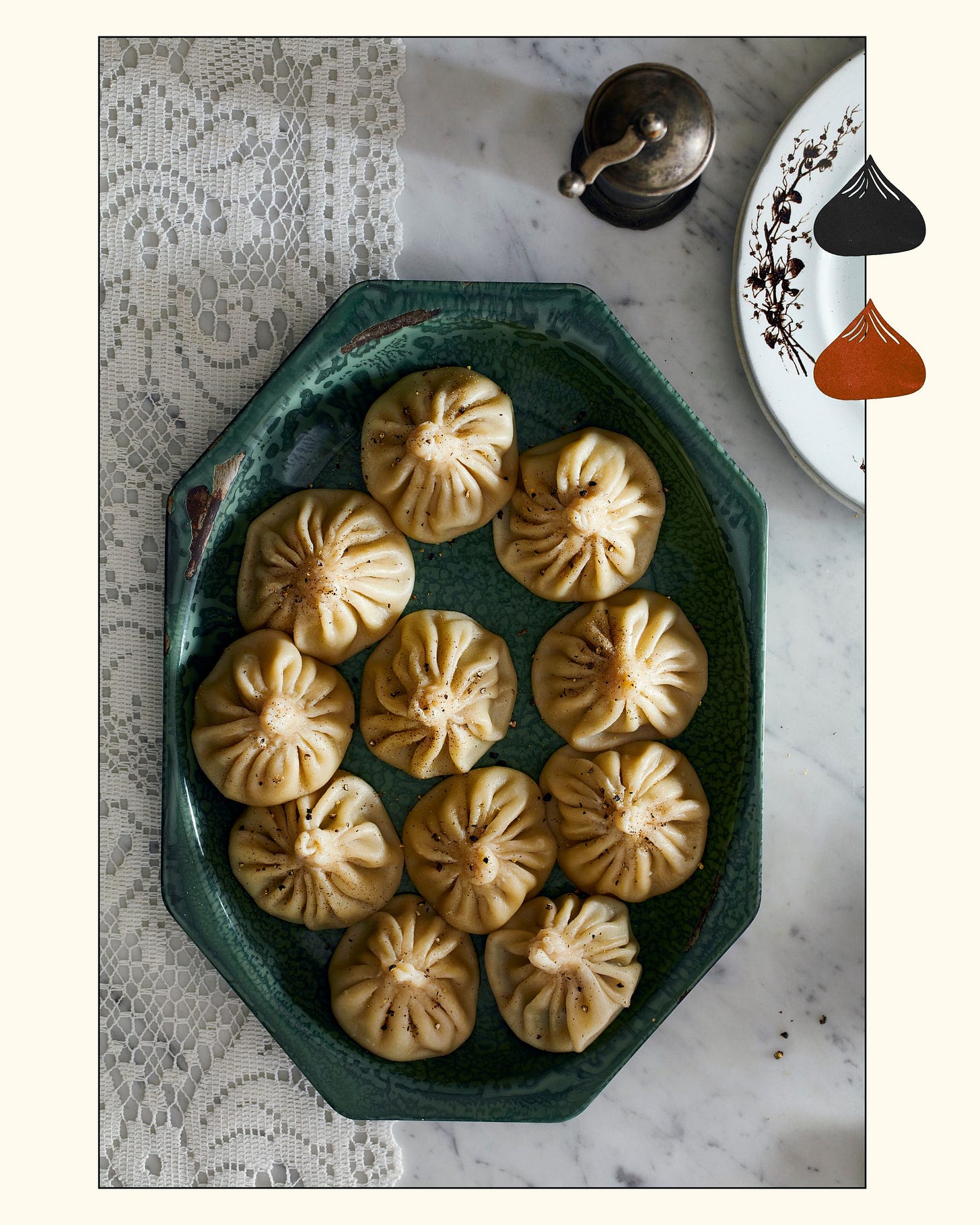 overhead photo of a platter of khinkali on a countertop with a lace tablecloth overhead photo of a platter of khinkali on a countertop with a lace tablecloth