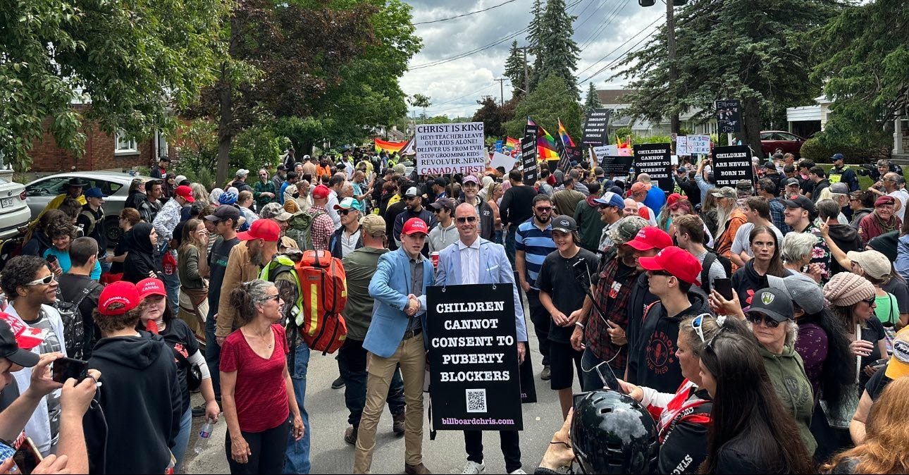 Billboard Chris at the center of a protest against Gender Ideology. He is surrounded by various supporters and there is a sign behind him stating "Christ is King" Billboard Chris at the center of a protest against Gender Ideology. He is surrounded by various supporters and there is a sign behind him stating "Christ is King"