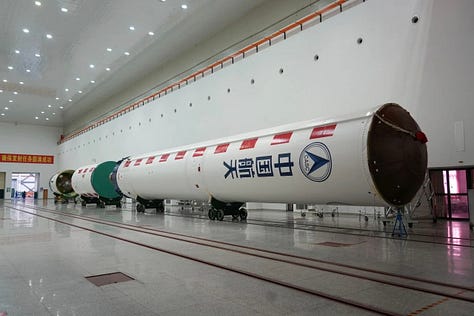 Hardware for the Long March 4C being prepared for launch and being hoisted atop of the vehicle.
