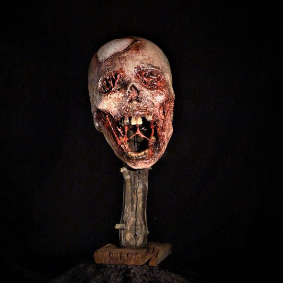 This may contain: a creepy looking head with blood on it
