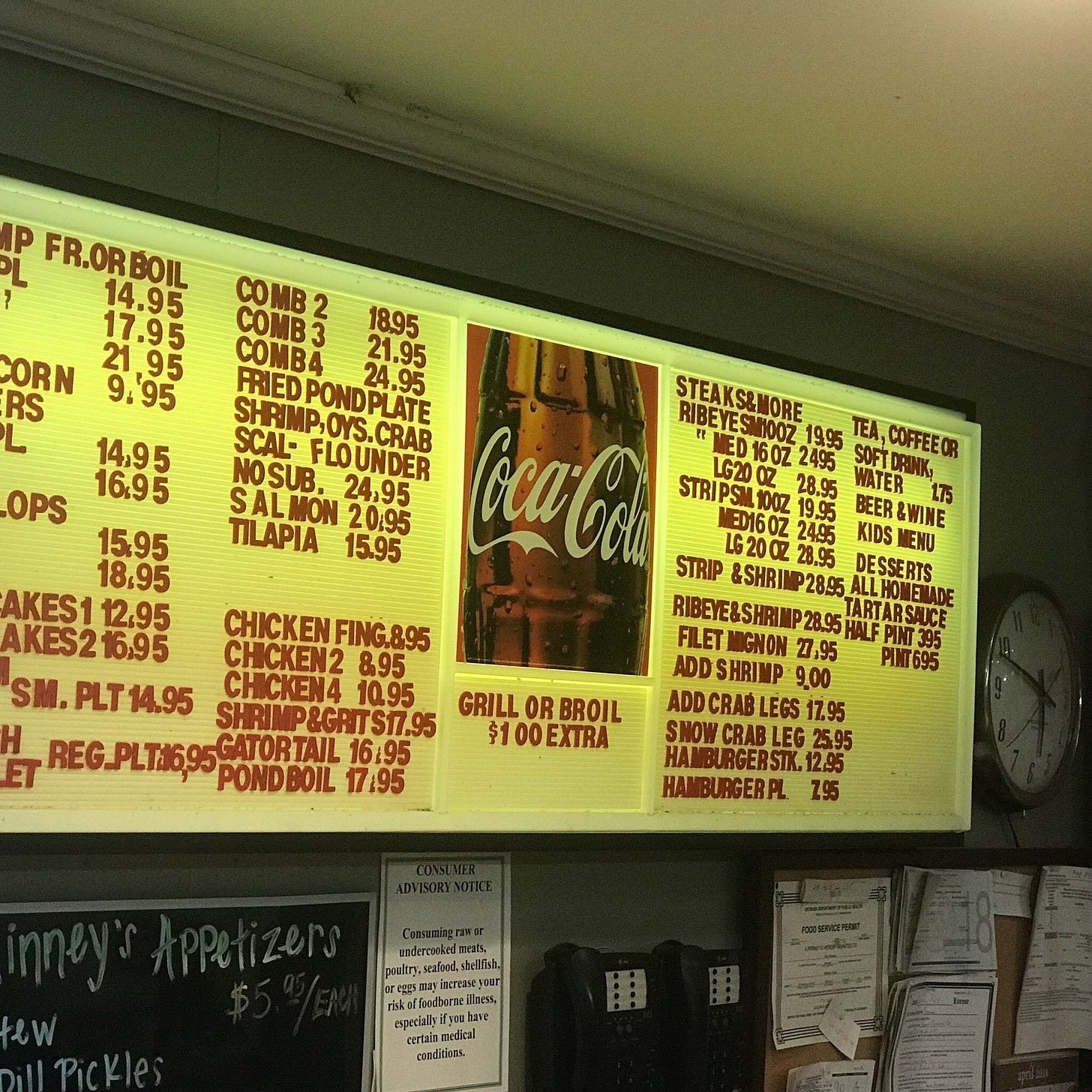 Photo of the old-school menu board at McKinney's pond. The board is illuminated from behind and plastic letters and slid into place. Common items are fried shrimp, gator tail, ribeye steaks, and french fries. Photo of the old-school menu board at McKinney's pond. The board is illuminated from behind and plastic letters and slid into place. Common items are fried shrimp, gator tail, ribeye steaks, and french fries.